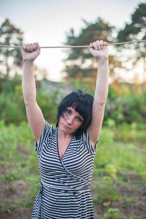 Portrait of young rural woman standing outdoors.の写真素材