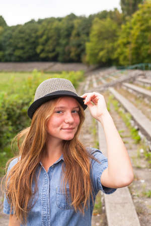 Cute young girl in a hat in a historic park. Tourism.の写真素材