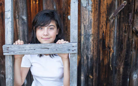 Cute teen girl posing near a house in the village.の写真素材