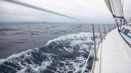 Sailing in the sea during deteriorating weather (cloudy weather). Cruise luxury yacht. Journey on...