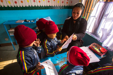 KATHMANDU, NEPAL - CIRCA DEC, 2013: Unknown pupils in English class at primary school. Only 50% of  children in Nepal can reach 5 grade.のeditorial素材