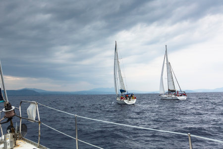 HYDRA, GREECE - CIRCA OCT, 2014: Unidentified sailboats participate in sailing regatta 12th Ellada Autumn 2014 among Greek island group in the Aegean Sea, in Cyclades and Argo-Saronic Gulf.のeditorial素材