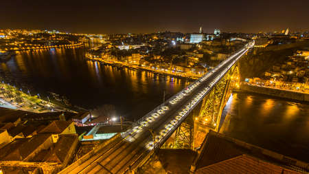 Top view of Ribeira and Douro river at night time in Porto, Portugal.
