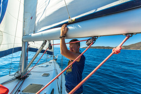 TRIZONIA, GREECE - CIRCA OCT, 2014: Unidentified sailors participate in sailing regatta 12th Ellada Autumn 2014 among Greek island group in the Aegean Sea, in Cyclades and Argo-Saronic Gulf.のeditorial素材