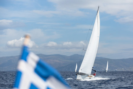 ANDROS, GREECE - CIRCA OCT, 2014: Sailboat participate in sailing regatta 12th Ellada Autumn 2014 among Greek island group in the Aegean Sea, in Cyclades and Argo-Saronic Gulf.のeditorial素材