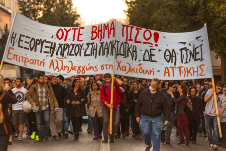 ATHENS, GREECE - APR 16, 2015: Anarchist protesters near Athens University, which has been occupied by protesters - voiced support for a hunger strike by prisoners convicted under anti-terrorism laws.のeditorial素材