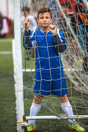 Teenager boy plays soccer at the stadium.の写真素材