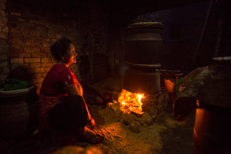 BHAKTAPUR, NEPAL - CIRCA DEC, 2013: Unidentified Nepalese woman working in the his pottery workshop. More 100 cultural groups have created an image Bhaktapur as Capital of Nepal Arts.のeditorial素材