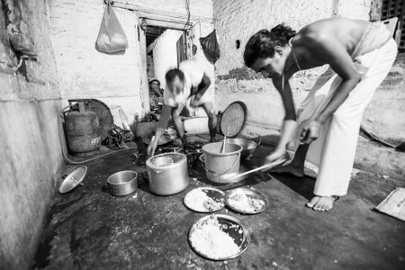 KATHMANDU, NEPAL - CIRCA DEC, 2013: Unknown people during dinner at Jagadguru School. School established at 2013, to let new generation learn Sanskrit and preserve Hindu culture.のeditorial素材