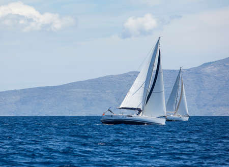 Sailing regatta. Sailing in the wind through the waves at the Aegean Sea in Greece. Luxury yachts.