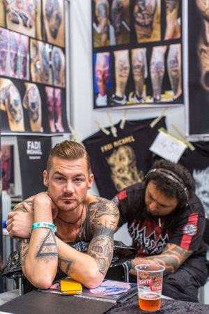 KRAKOW, POLAND - JUNE 6, 2015: People make a tattoos at the 10-th International Tattoo Convention in the Congress-EXPO Center. This year anniversary TattooFest is tattoo Studio with an area of 2000m2.のeditorial素材