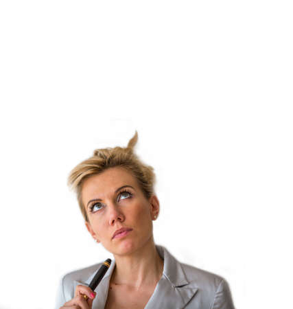 Business woman with pencil looks upwards. Space for text, isolated on white background.の写真素材