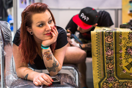 KRAKOW, POLAND - JUNE 6, 2015: People make a tattoos at the 10-th International Tattoo Convention in the Congress-EXPO Center. This year anniversary TattooFest is tattoo Studio with an area of 2000m2.のeditorial素材