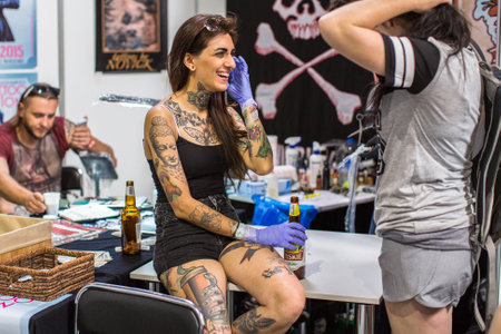 KRAKOW, POLAND - JUNE 6, 2015: Unidentified participants at 10-th International Tattoo Convention in Congress-EXPO Center. This year anniversary TattooFest - tattoo Studio is with an area of 2000m2のeditorial素材
