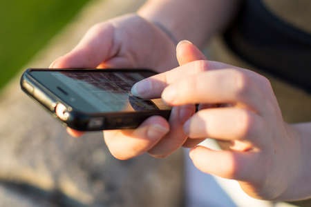 Close-up of hands woman using smartphone.