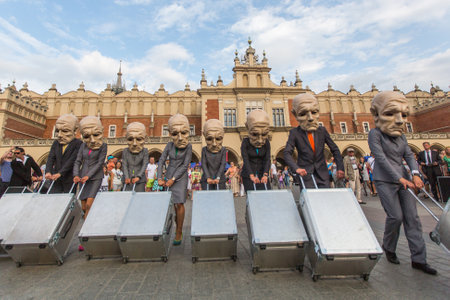 KRAKOW, POLAND - JUL 12, 2015: Participants at the annually (Jul 9-12) 28th International Festival of Street Theatres - Teatr KTO (PL) Peregrinus in Main Square and at random points around the city.のeditorial素材