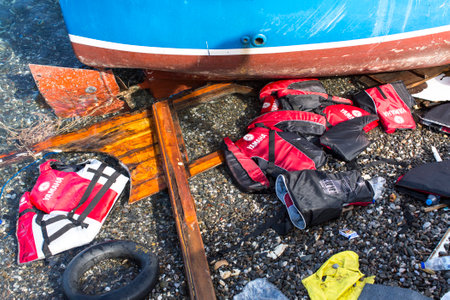 KOS, GREECE - SEP 27, 2015: Life Jackets discarded on a beach. Kos island is located just 4 kilometers from the Turkish coast and refugees come from Turkey in an inflatable boat.のeditorial素材