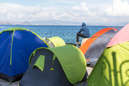 KOS, GREECE - SEP 28, 2015: Tents war refugees in the port of Kos island. Kos island is located just 4 kilometers from the Turkish coast, and many refugees come from Turkey in an inflatable boats.のeditorial素材