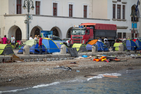KOS, GREECE - SEP 28, 2015: Tents war refugees in the port of Kos island. Kos island is located just 4 kilometers from the Turkish coast, and many refugees come from Turkey in an inflatable boats.のeditorial素材