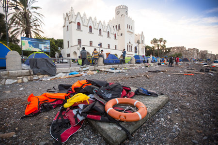 KOS, GREECE - SEP 28, 2015: Life Jackets discarded and sunken Turkish boat in the port. Kos island is located just 4 kilometers from the Turkish coast, and many refugees come from Turkey in boats.のeditorial素材