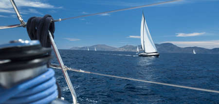 Sailing regatta. Ship yachts with white sails in the open Sea. Luxury boats.