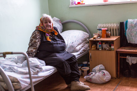 VINNITSY, RUSSIA - NOV 30, 2015: Elderly woman in rehabilitation department in Center of social services for pensioners and the disabled. 2015 - the year of the older generation in Leningrad region.のeditorial素材