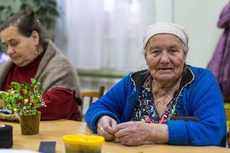 VINNITSY, RUSSIA - NOV 30, 2015: Elderly woman in rehabilitation department in Center of social services for pensioners and the disabled. 2015 - the year of the older generation in Leningrad region.のeditorial素材
