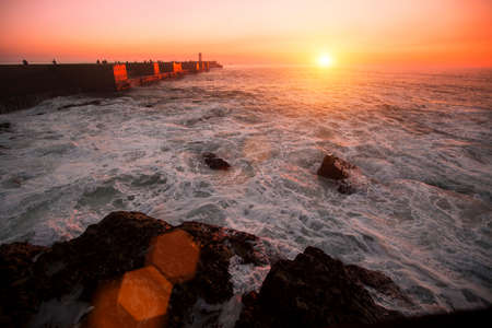 Pier in the Ocean, during amazing bloody sunset.