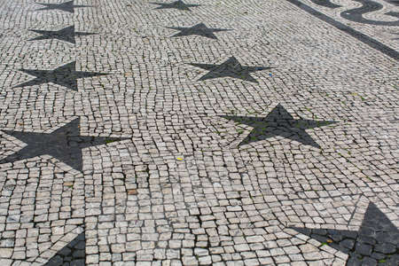 Pavement paved with stone figures in the form of stars.の写真素材