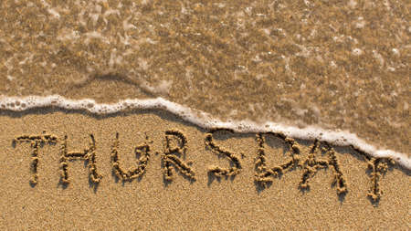Inscription THURSDAY on a gentle beach sand with the soft wave (days of the week series)の写真素材