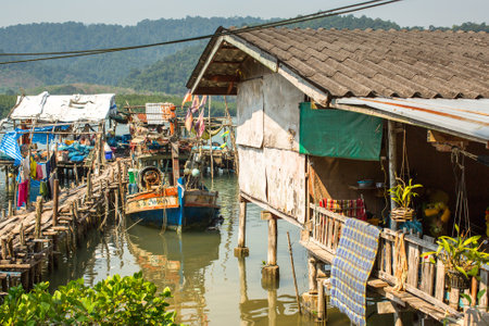 KOH CHANG, THAILAND - FEB 4, 2016: Huts and fishing boat at the pier in at fisherman village. In Thailand second most important occupation is fishing more 3% of population.のeditorial素材