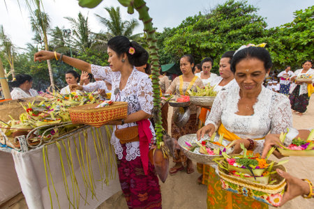 SANUR, BALI - MAR 18, 2016: Unidentified local people during ceremony Melasti Ritual. Melasti is a Hindu Balinese purification ceremony and one of the most important rituals of Bali island.のeditorial素材