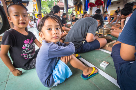 UBUD, BALI / INDONESIA - MAR 1, 2016: Unidentified children at the time of preparations for Ngrupuk parade, which takes place on the eve of Nyepi day in Bali. Nyepi is a public holiday in Indonesia.のeditorial素材