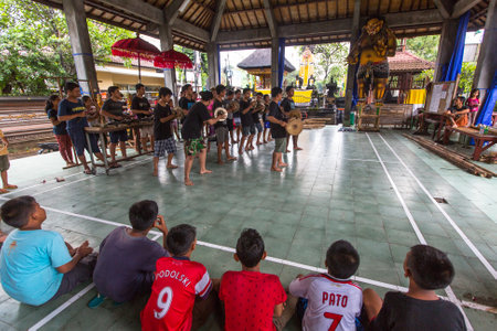 UBUD, BALI / INDONESIA - MAR 1, 2016: Unidentified teenagers at the time of preparations for Ngrupuk parade, which takes place on the eve of Nyepi day in Bali. Nyepi is a public holiday in Indonesia.のeditorial素材