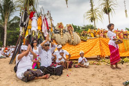SANUR, BALI - MAR 18, 2016: Unidentified local people during performed Melasti Ritual. Melasti is a Hindu Balinese purification ceremony and ritual is held several days prior to the Nyepi holy day.のeditorial素材