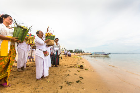 SANUR, BALI - MAR 18, 2016: Unidentified people during Melasti Ritual. Ceremony is held on the edge of the beach with the aim to purify oneself of all the bad things in the past and throw it to ocean.のeditorial素材