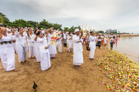 SANUR, BALI - MAR 18, 2016: Unidentified local people during performed Melasti Ritual. Melasti is a Hindu Balinese purification ceremony and ritual is held several days prior to the Nyepi holy day.のeditorial素材
