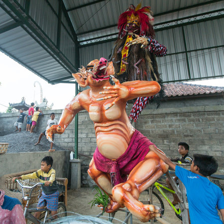 BALI, INDONESIA - MAR 7, 2016: Unidentified local people during built Ogoh-ogoh are statues for the Ngrupuk parade, which takes place on the eve of Nyepi day. Nyepi is a public holiday in Indonesia.のeditorial素材