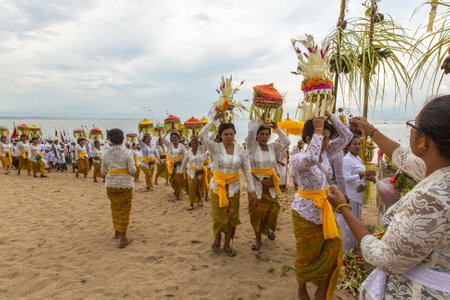 SANUR, BALI - MAR 18, 2016: Unidentified people during Melasti Ritual. Ceremony is held on the edge of the beach with the aim to purify oneself of all the bad things in the past and throw it to ocean.のeditorial素材