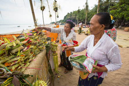 SANUR, BALI - MAR 18, 2016: Unidentified local people during performed Melasti Ritual. Melasti is a Hindu Balinese purification ceremony and ritual is held several days prior to the Nyepi holy day.のeditorial素材