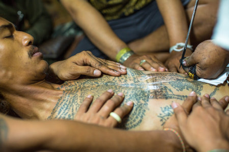 WAT BANG PHRA, THAILAND - MART 18, 2016: Unidentified monk makes traditional Yantra tattooing during Wai Kroo Master Day Ceremony in Bang Pra monastery, about 50 km west of Bangkok.のeditorial素材