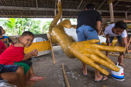 UBUD, INDONESIA - MAR 1, 2016: Unidentified local people during built Ogoh-ogoh are statues for the Ngrupuk parade, which takes place on the eve of Nyepi day. Nyepi is a public holiday in Indonesia.のeditorial素材