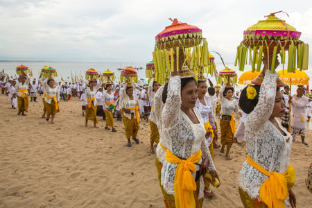 SANUR, BALI - MAR 18, 2016: Unidentified local people during performed Melasti Ritual. Melasti is a Hindu Balinese purification ceremony and ritual is held several days prior to the Nyepi holy day.のeditorial素材