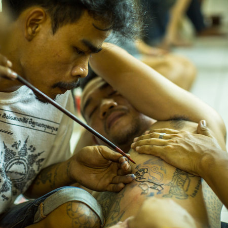 WAT BANG PHRA, THAILAND - MAR 18, 2016: Unidentified monk makes traditional Yantra tattooing during Wai Kroo Master Day Ceremony in Bang Pra monastery, about 50 km west of Bangkok.のeditorial素材