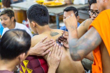 WAT BANG PHRA, THAILAND - MAR 18, 2016: Unidentified monk makes traditional Yantra tattooing during Wai Kroo Master Day Ceremony in Bang Pra monastery, about 50 km west of Bangkok.のeditorial素材