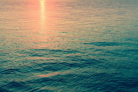 Reflection of the sunset in the emerald sea water.の写真素材