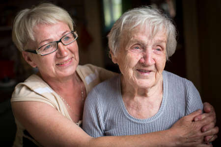 An elderly woman with her adult daughter.
