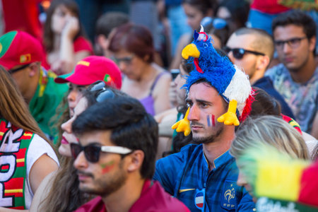 PORTO, PORTUGAL - JUL 10, 2016: French fan during video translation of the football match Portugal - France final of the European championship 2016, in Liberdade Square at city center of Porto.のeditorial素材