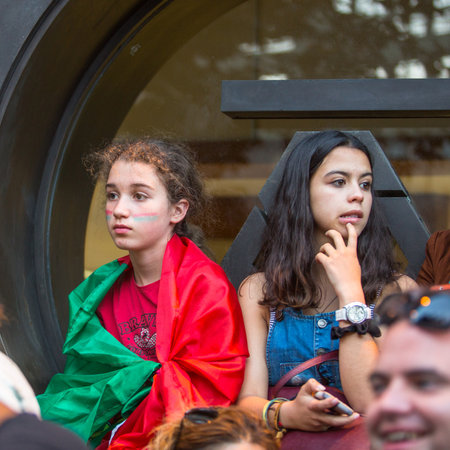 PORTO, PORTUGAL - JUL 10, 2016: Portuguese fans during video translation of the football match Portugal - France final of the European championship 2016, in Liberdade Square at city center of Porto.のeditorial素材