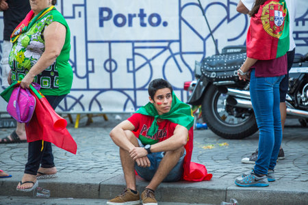 PORTO, PORTUGAL - JUL 10, 2016: Portuguese fans during video translation of the football match Portugal - France final of the European championship 2016, in Liberdade Square at city center of Porto.のeditorial素材